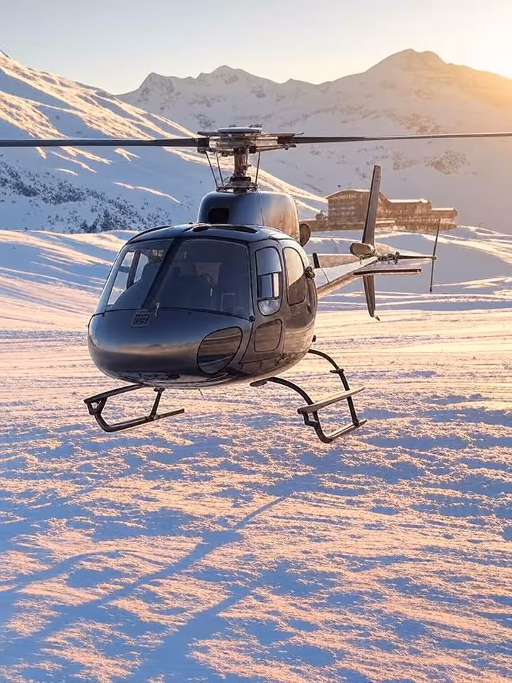 Private helicopter on snowy mountain landing pad with exclusive ski resort background, ultra-luxury 