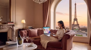 Elegant young woman in designer dress watching Emily in Paris on laptop in chic Parisian apartment w